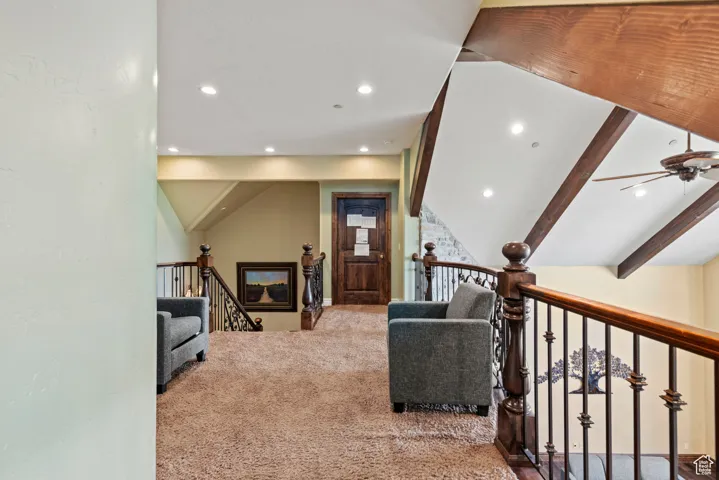 Interior space featuring recessed lighting, a ceiling fan, an upstairs landing, and carpet floors