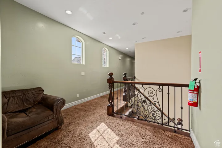 Interior space with recessed lighting, baseboards, an upstairs landing, and carpet floors