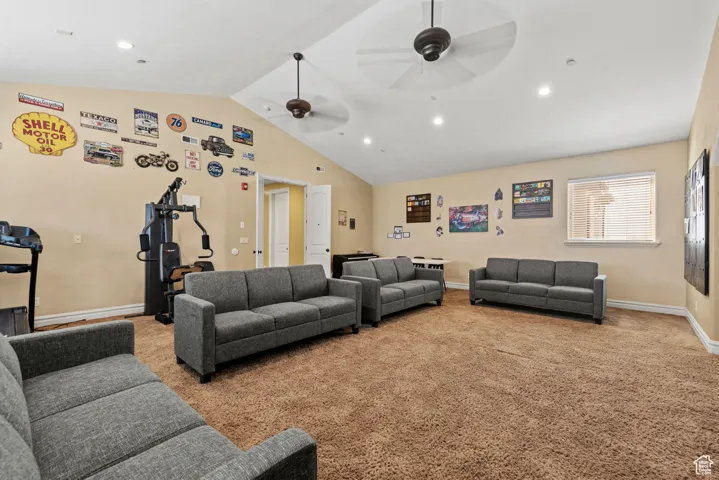 Carpeted living area with recessed lighting, baseboards, vaulted ceiling, and a ceiling fan