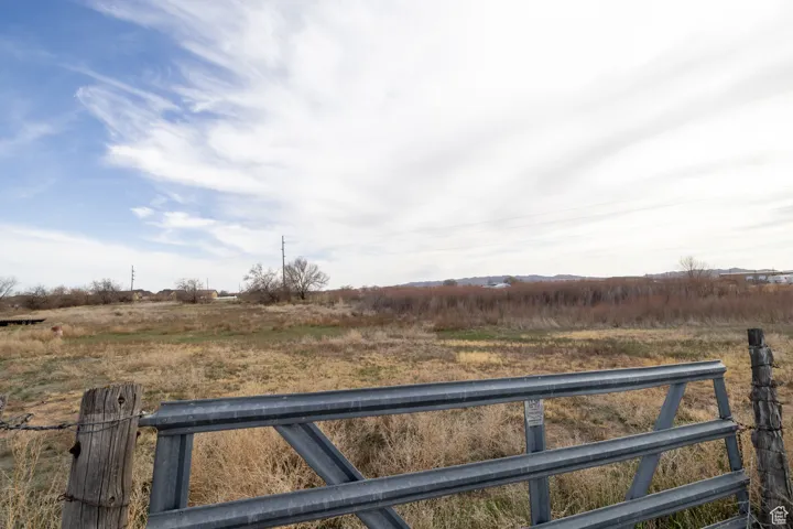 View of gate with a rural view