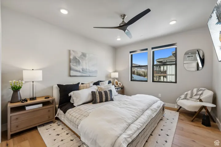 Bedroom with recessed lighting, light wood-style flooring, a ceiling fan, and baseboards