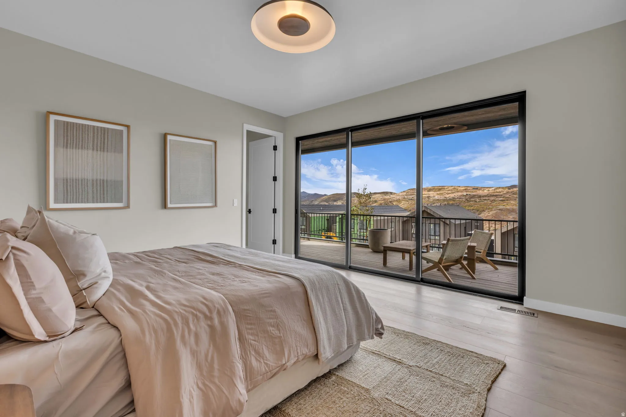 Bedroom with access to outside, a mountain view, and wood finished floors