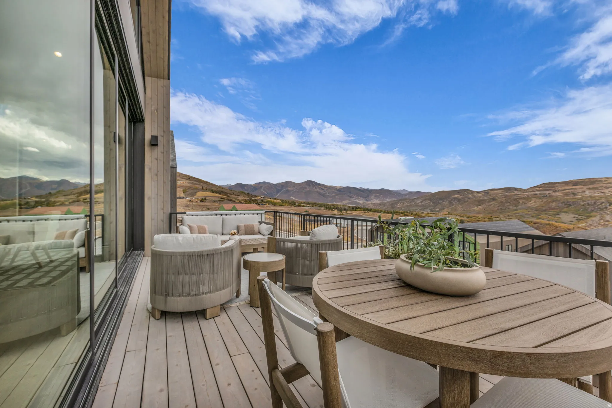 Wooden deck featuring a mountain view and outdoor lounge area