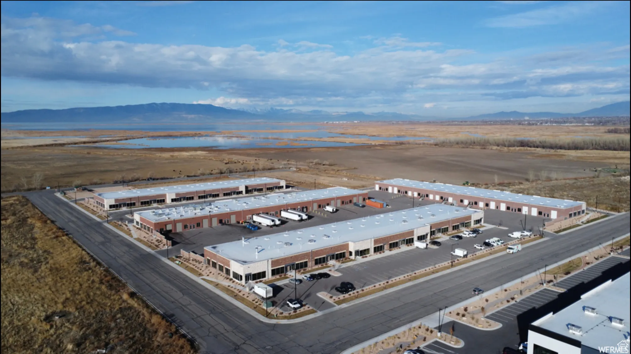 Drone / aerial view featuring a water and mountain view