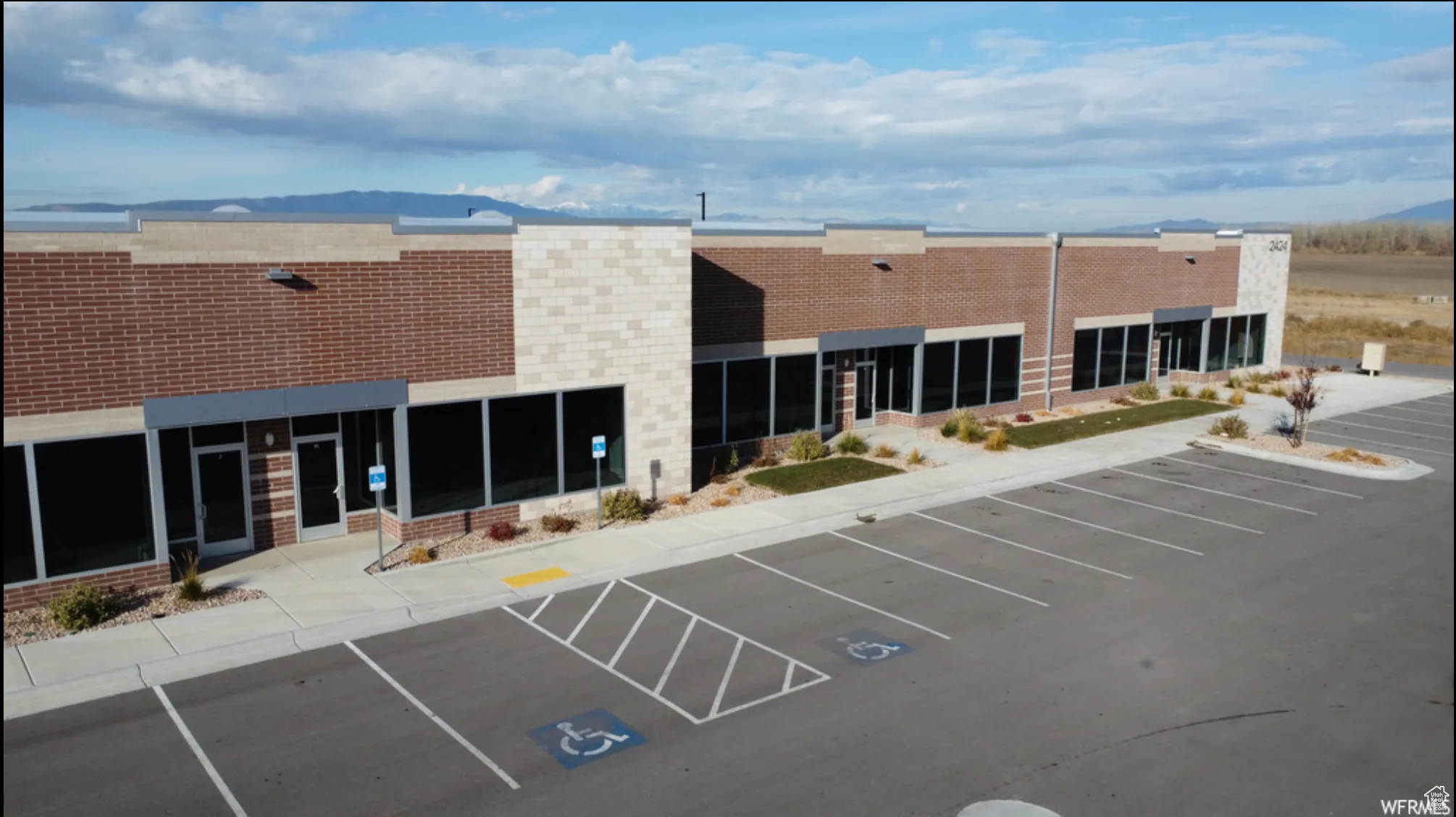 View of property with uncovered parking