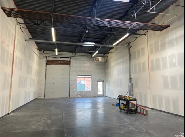 Garage featuring a wall mounted AC