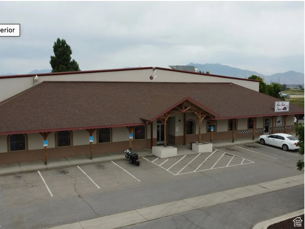 View of property featuring uncovered parking and a mountain view