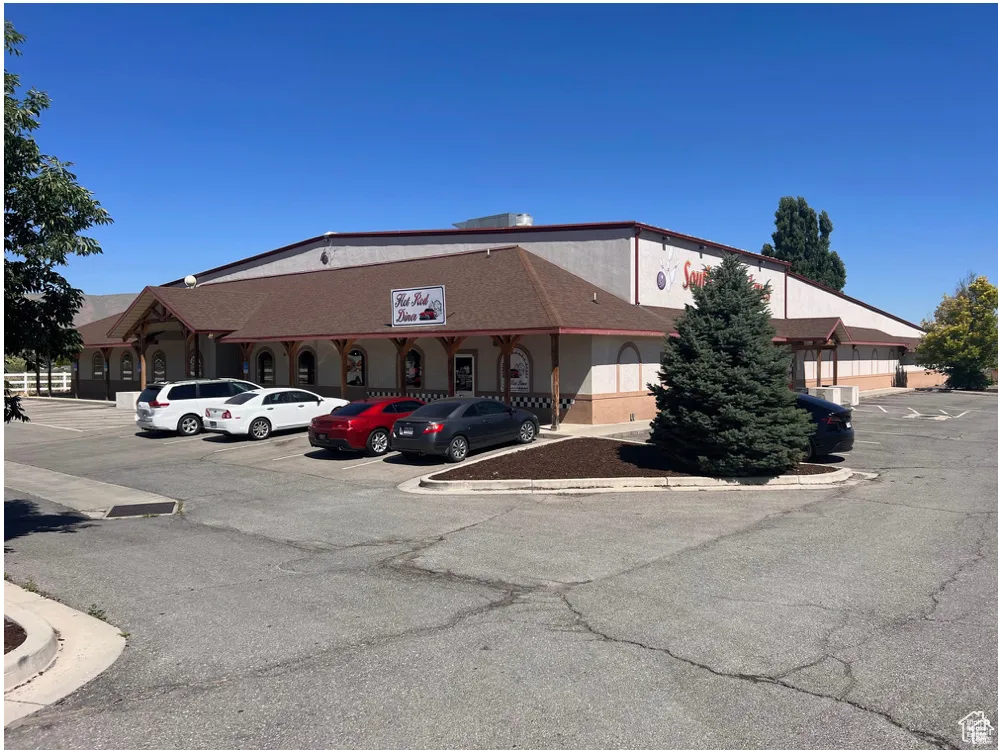 View of building exterior featuring uncovered parking