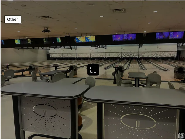 Interior space featuring a paneled ceiling, visible vents, and bowling