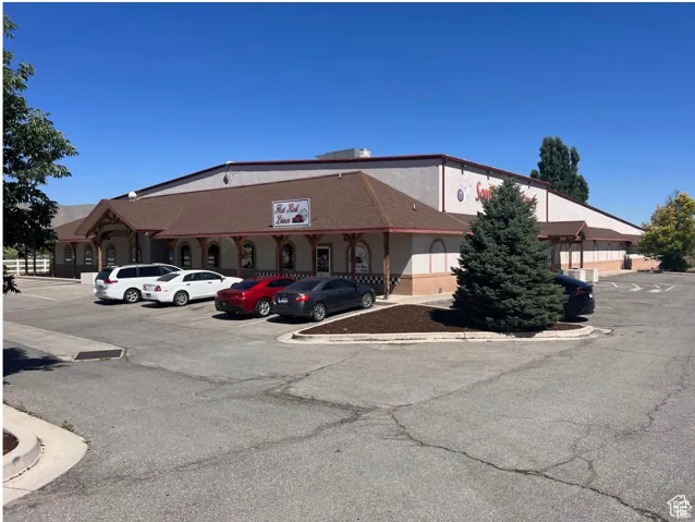 View of building exterior featuring uncovered parking