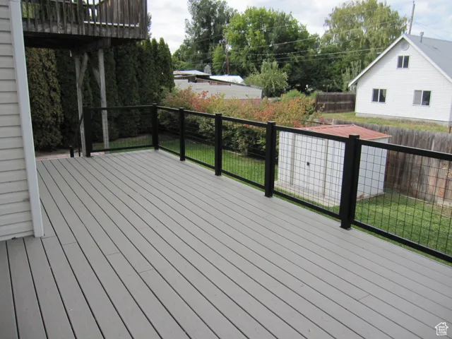 Wooden terrace featuring fence