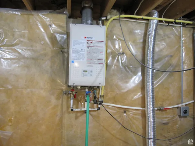 Utility room featuring tankless water heater