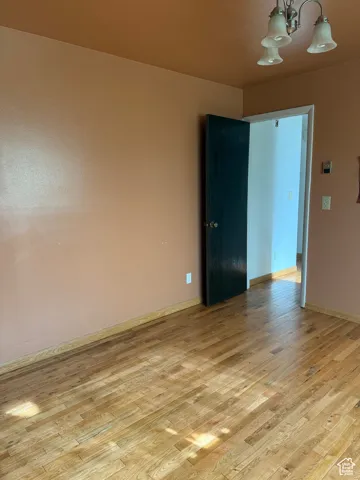 Unfurnished room with baseboards and light wood-style floors