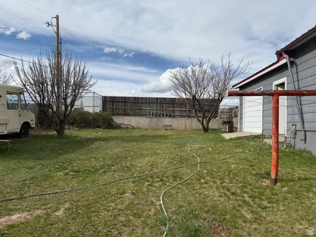 View of yard featuring fence