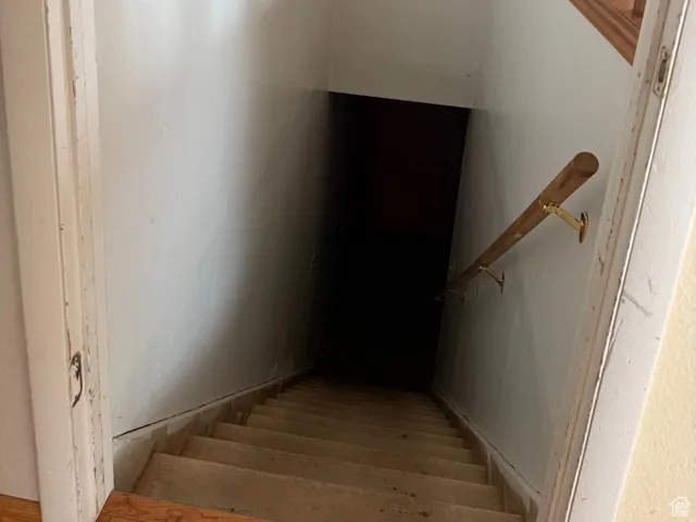 Staircase featuring wood finished floors