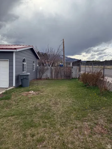 View of yard featuring fence