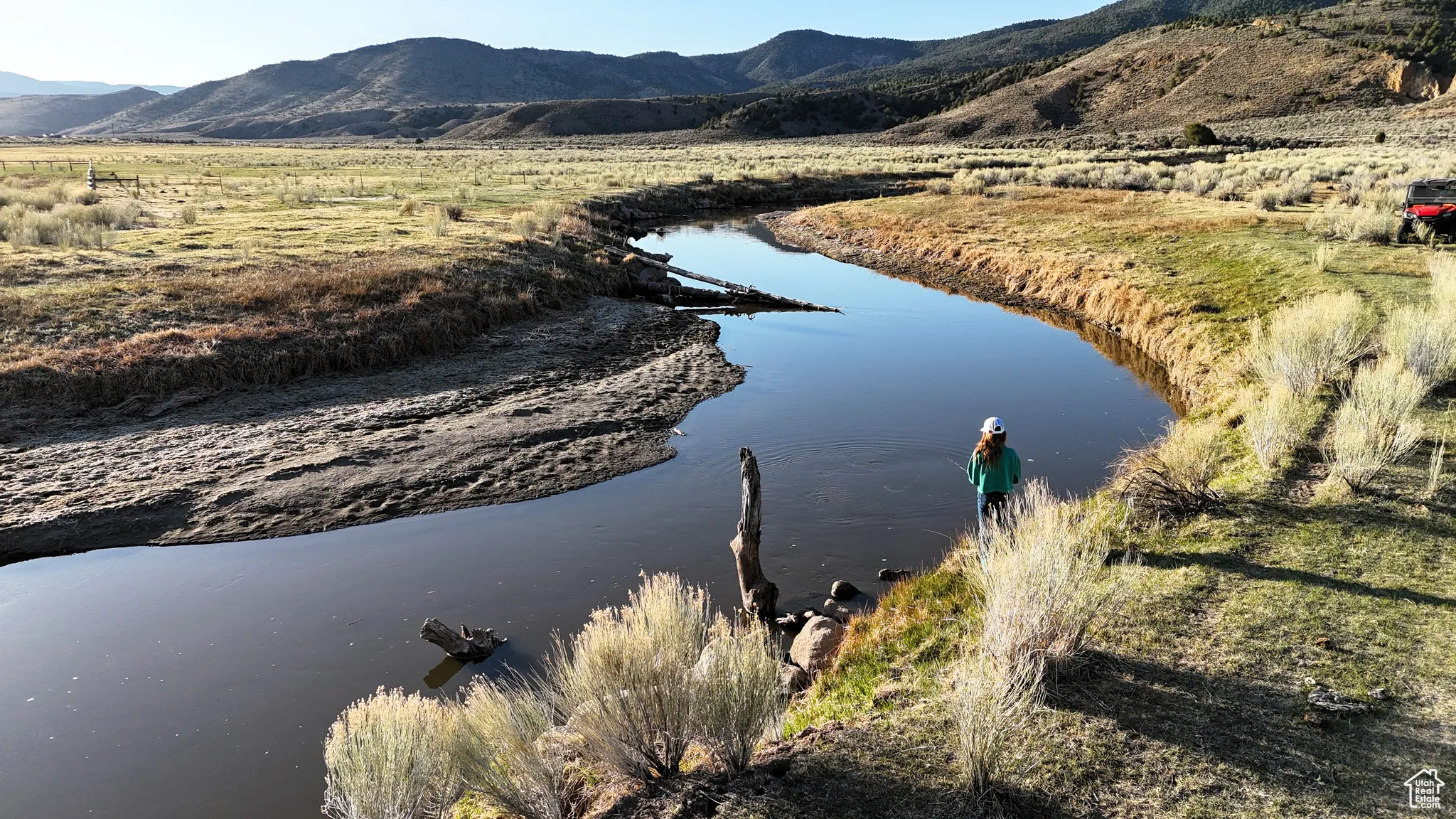 Birds eye view of property featuring a water and mountain view