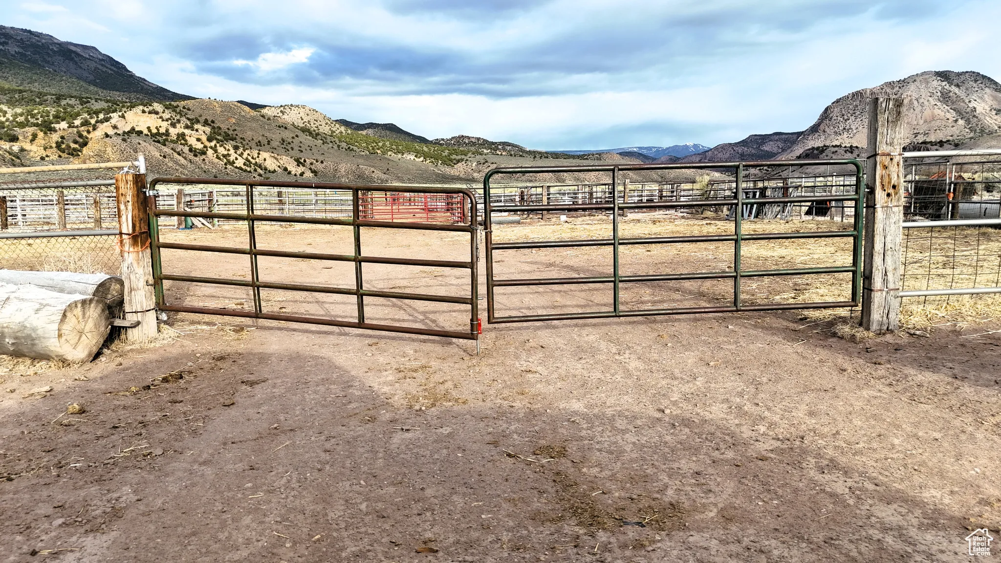 View of gate featuring fence, a rural view, and a mountain view