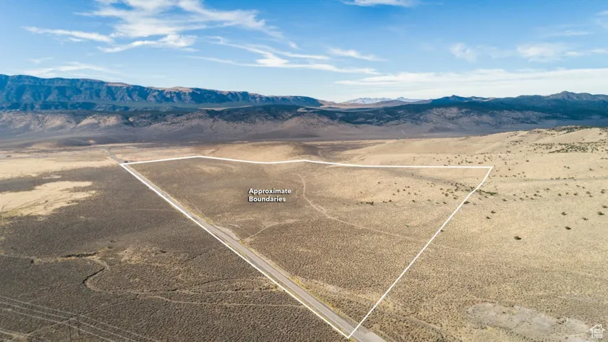 Drone / aerial view with a rural view, view of desert, and a mountain view