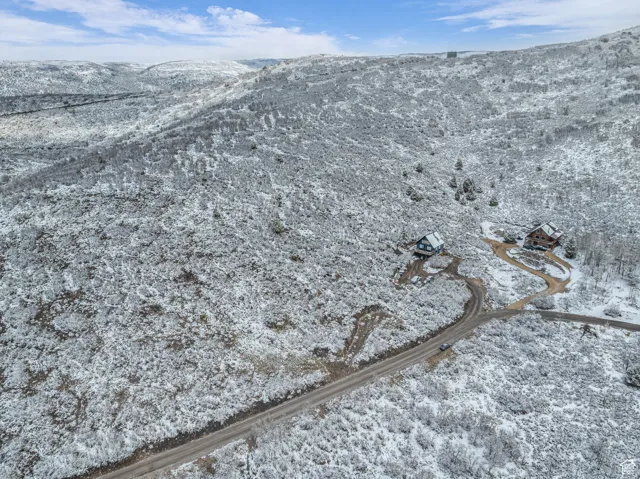 Snowy aerial view featuring a mountain view
