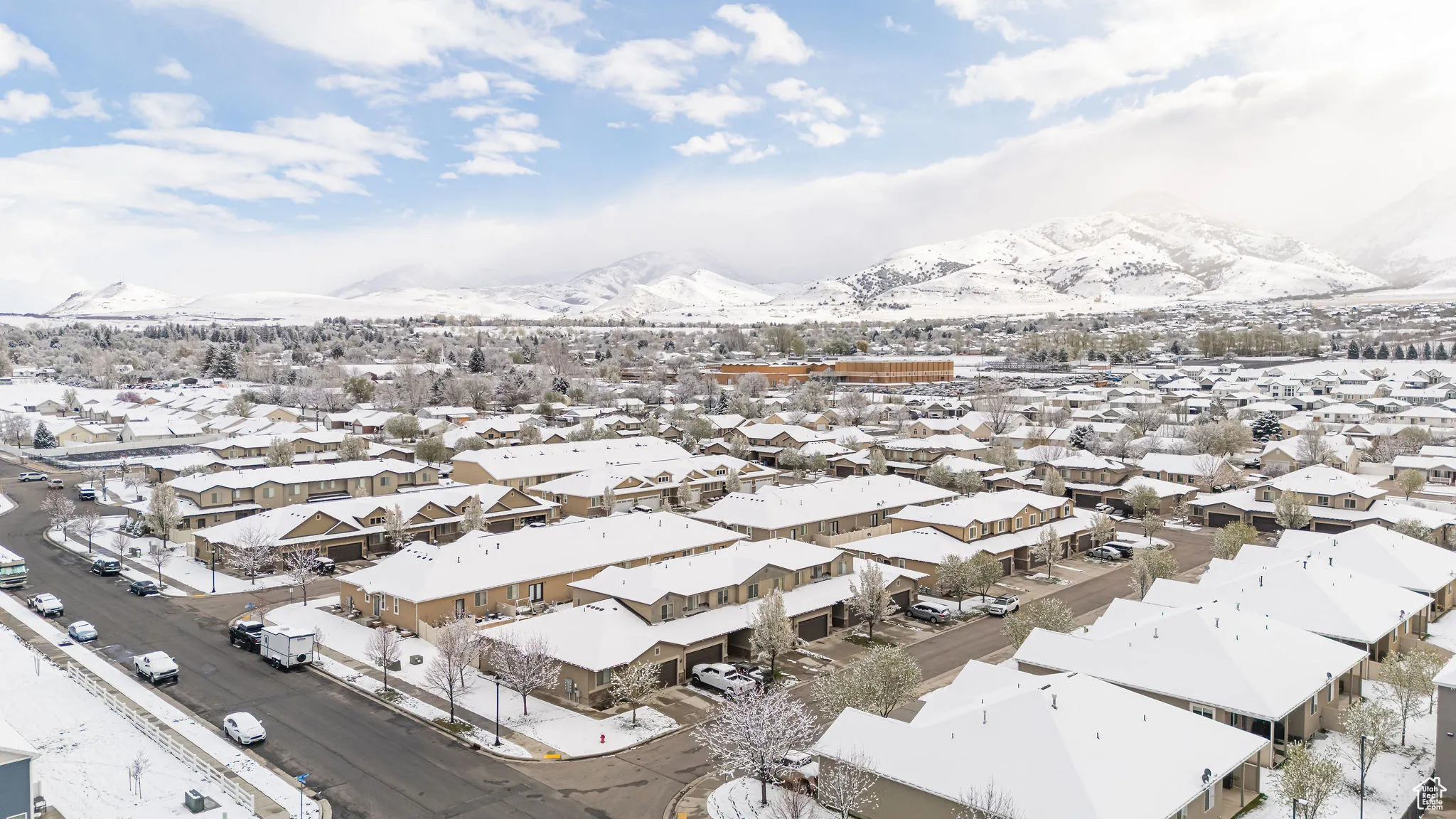 Snowy aerial view with a residential view and a mountain view