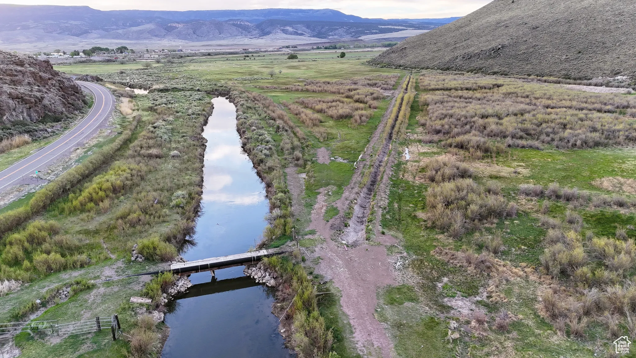Aerial view of property's location with a water and mountain view and a notable bridge