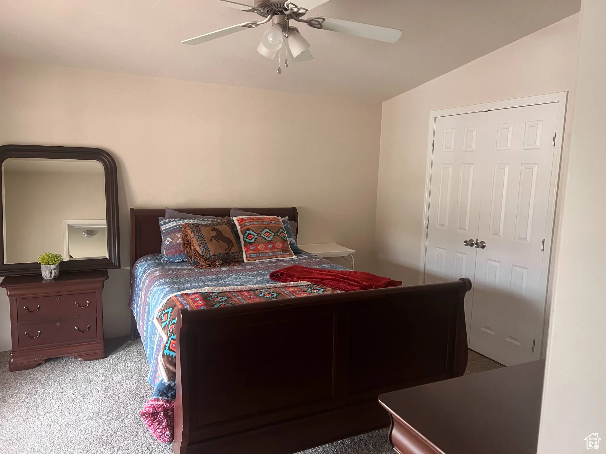Bedroom featuring carpet flooring, lofted ceiling, and ceiling fan