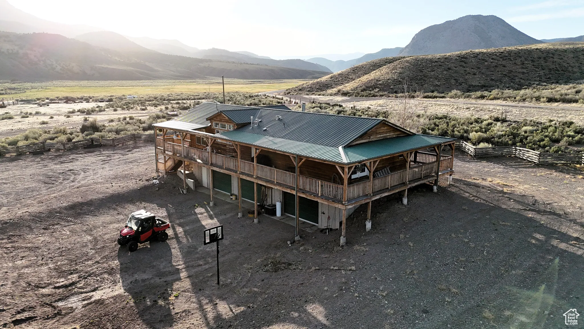 Back of property with a deck with mountain view and metal roof