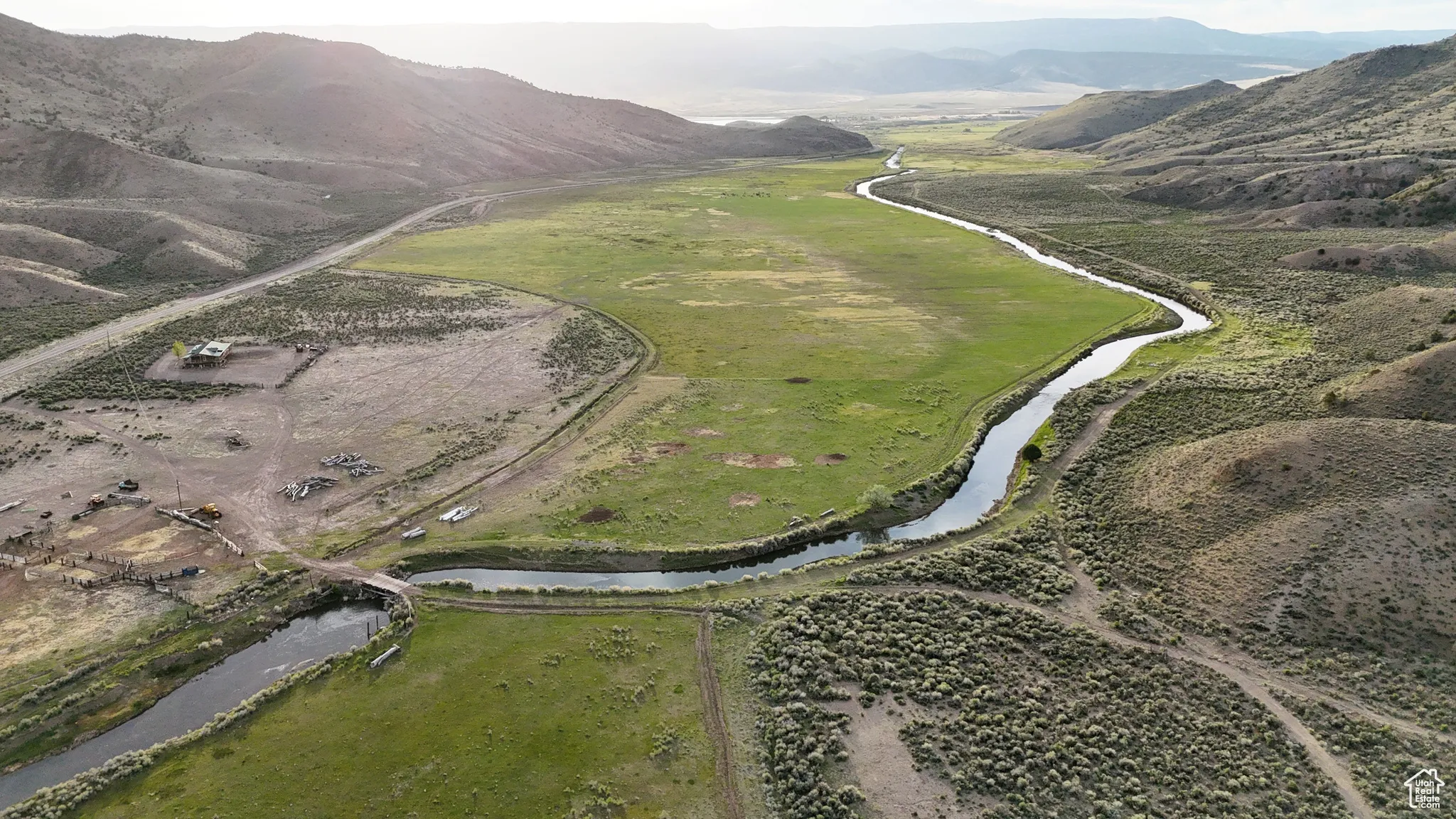 Aerial view of property and surrounding area with a water and mountain view