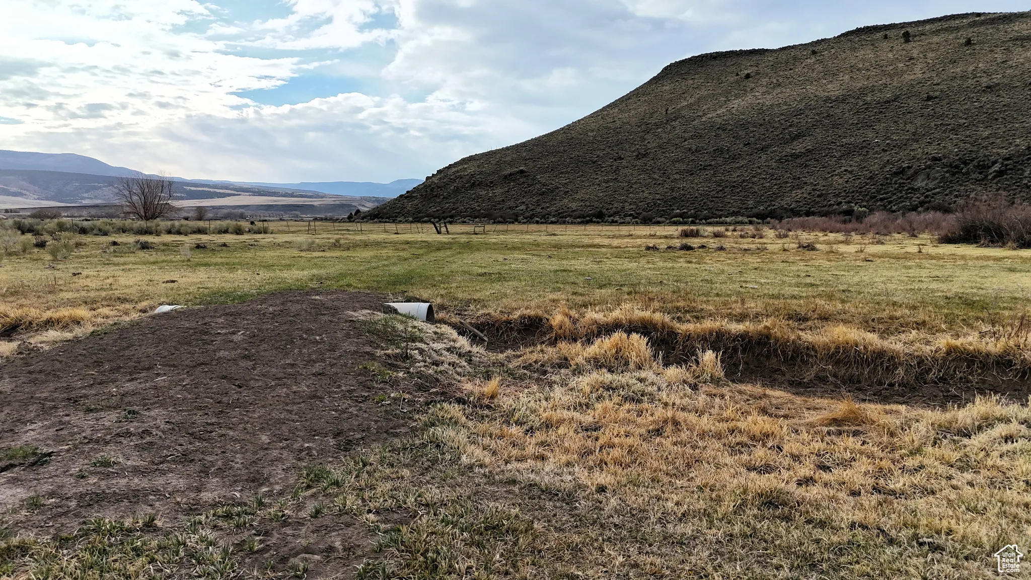 View of mountain backdrop with rural landscape