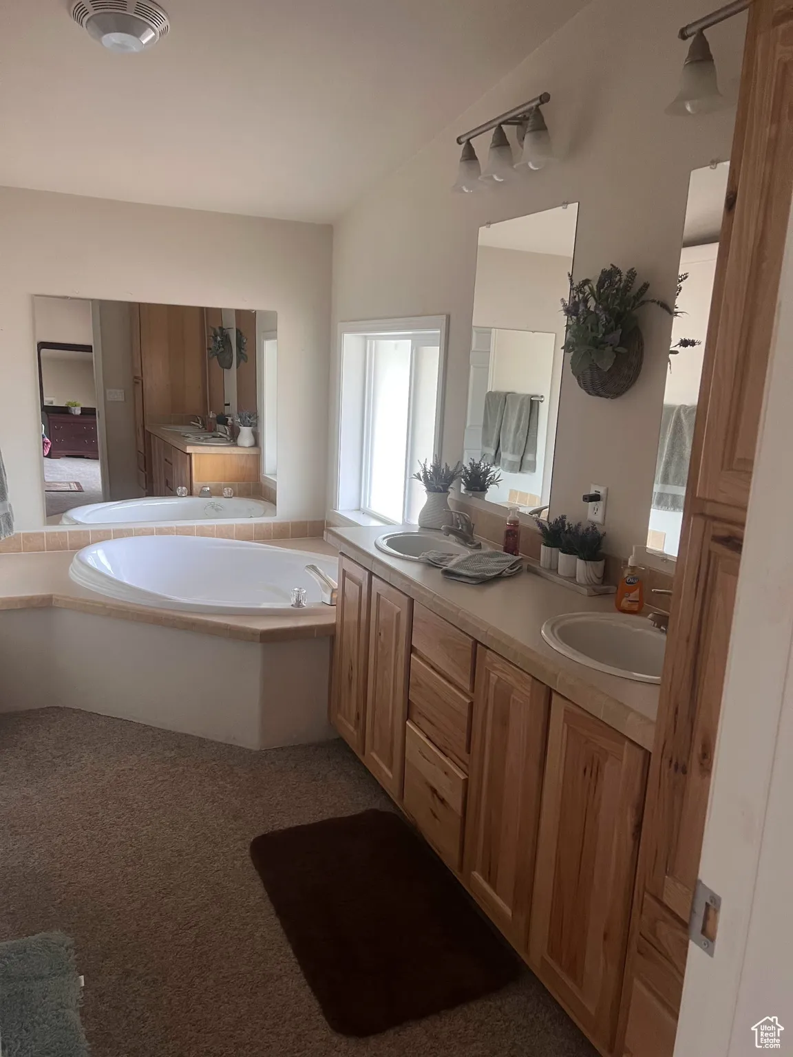Full bathroom with double vanity and a bath