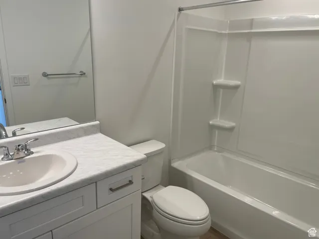 Full bathroom featuring toilet, vanity, and bathtub / shower combination