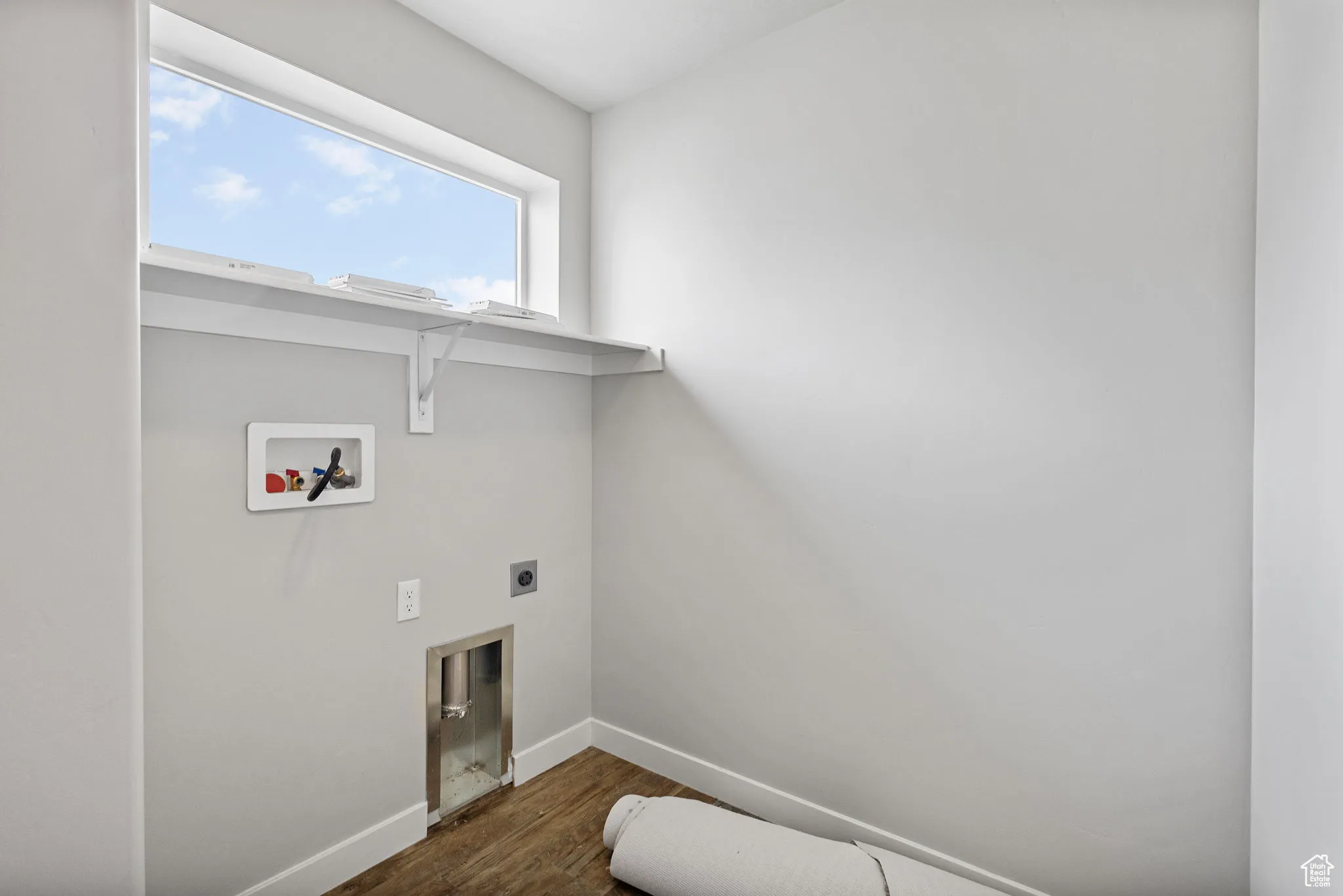 Washroom with dark wood-style flooring, electric dryer hookup, and hookup for a washing machine