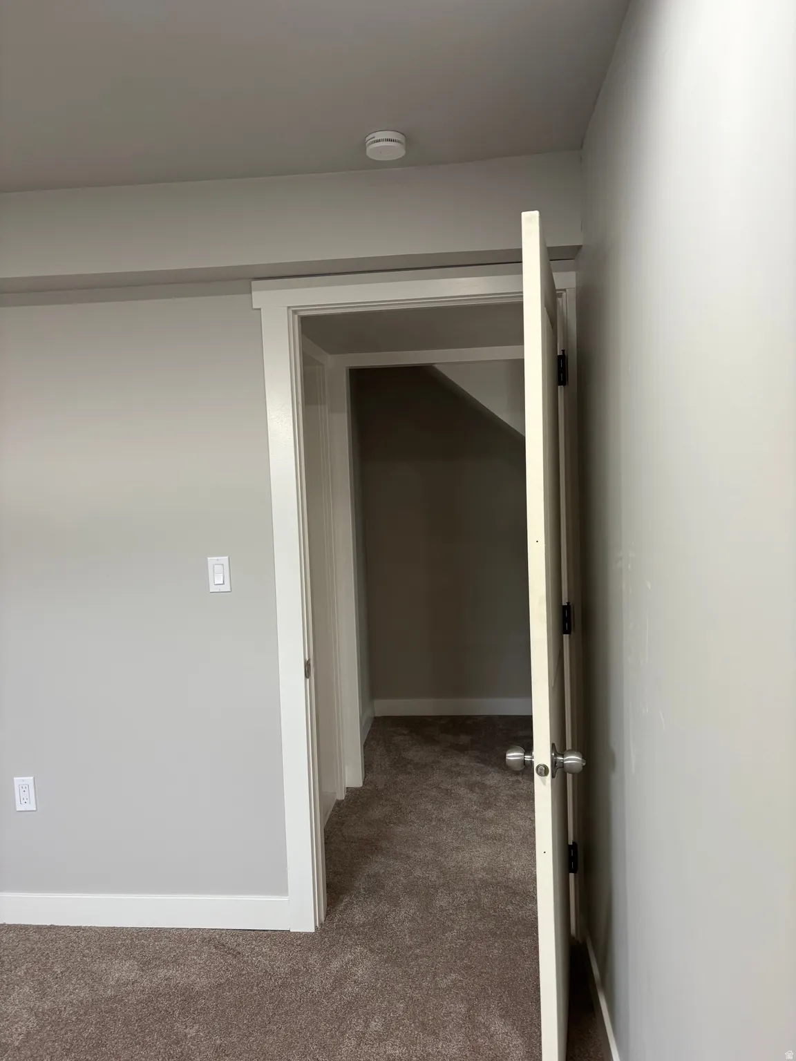 Hall featuring carpet floors and baseboards