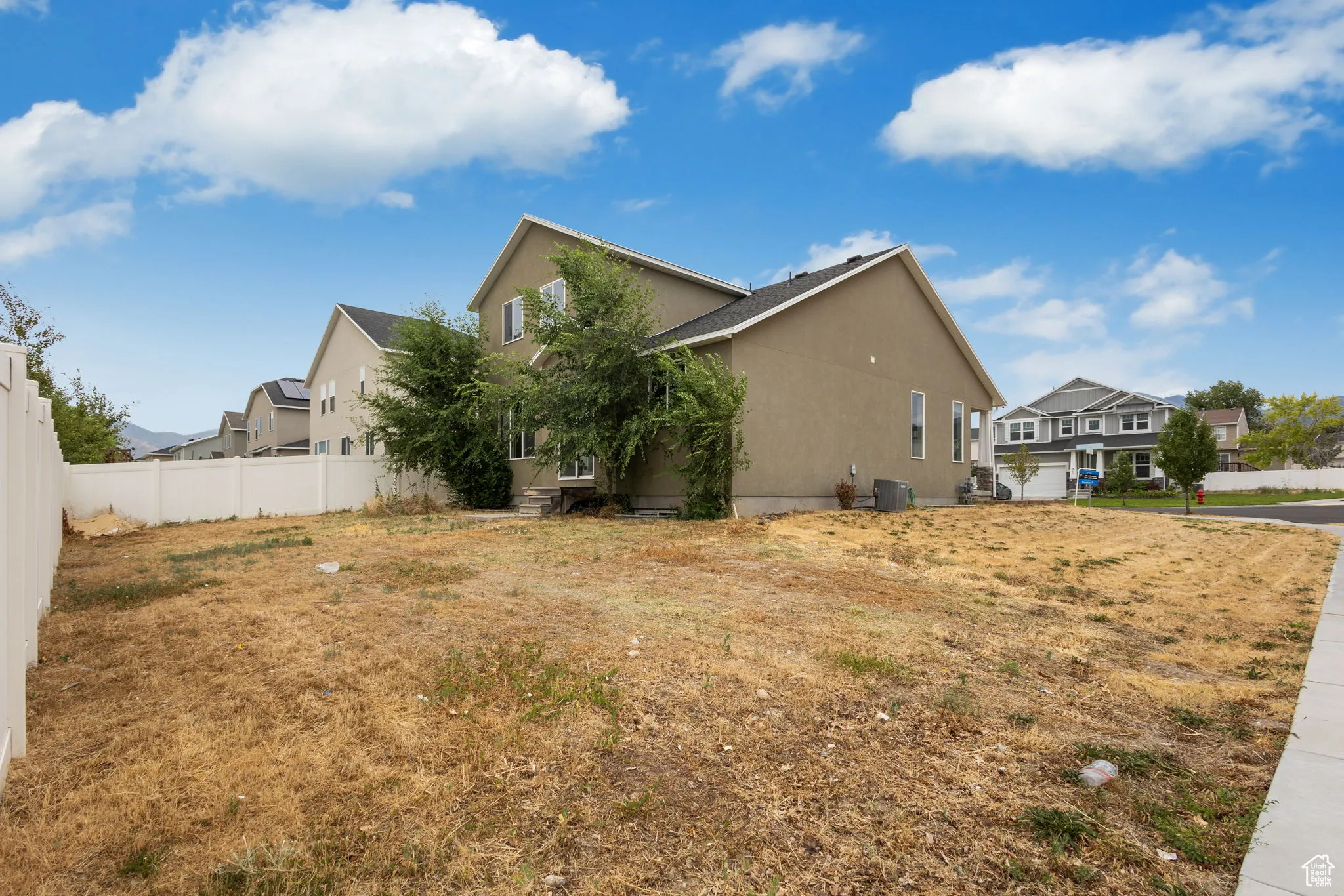 View of side of property featuring stucco siding and a residential view