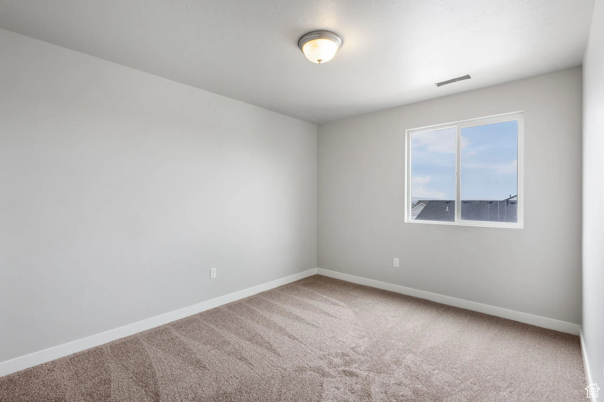 Unfurnished room with carpet flooring and baseboards