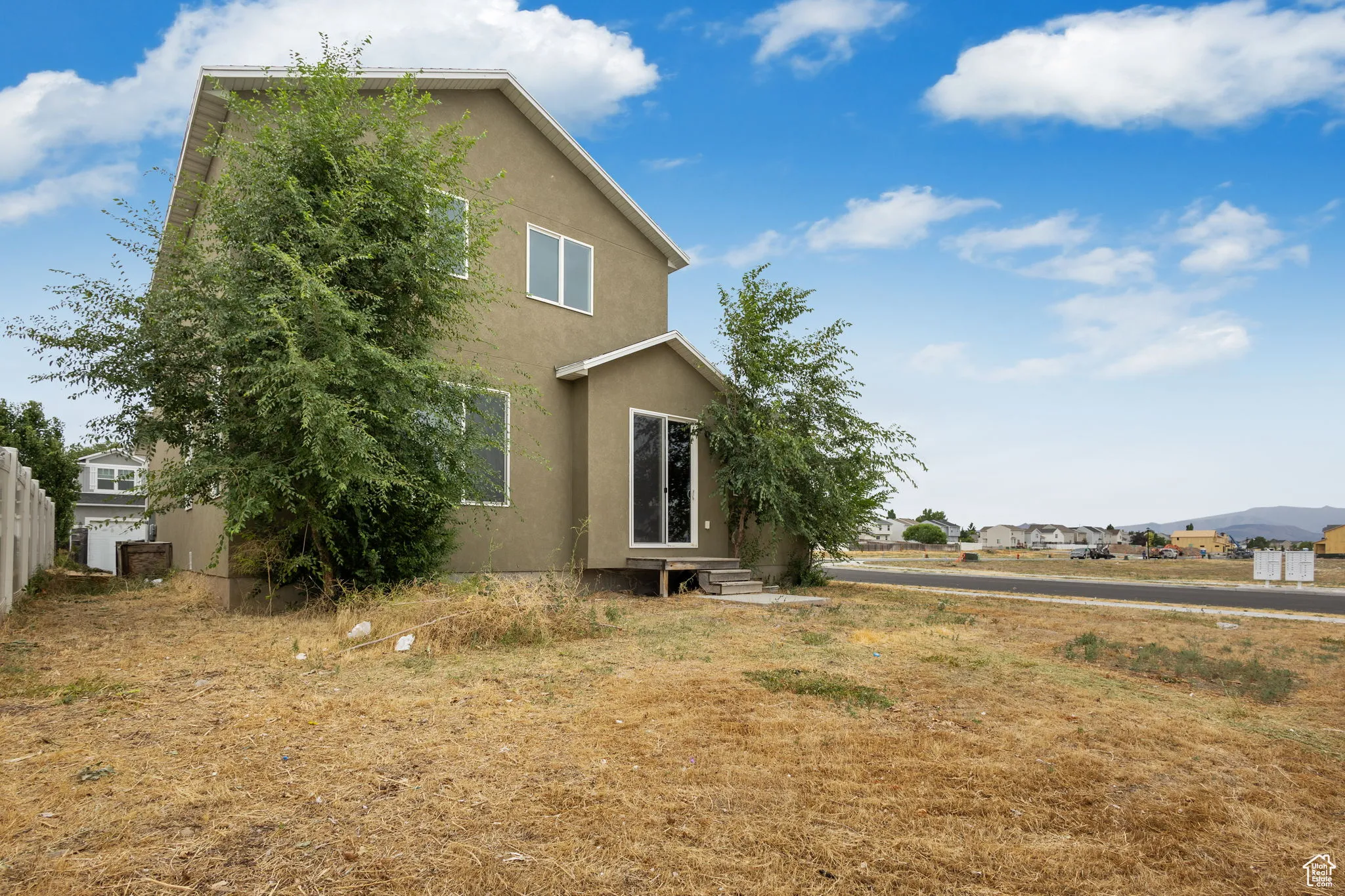 View of front of home with stucco siding and entry steps