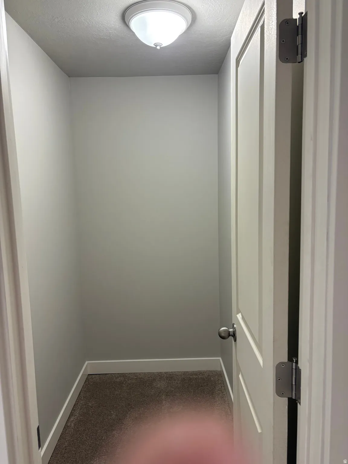 Spare room featuring baseboards and a textured ceiling