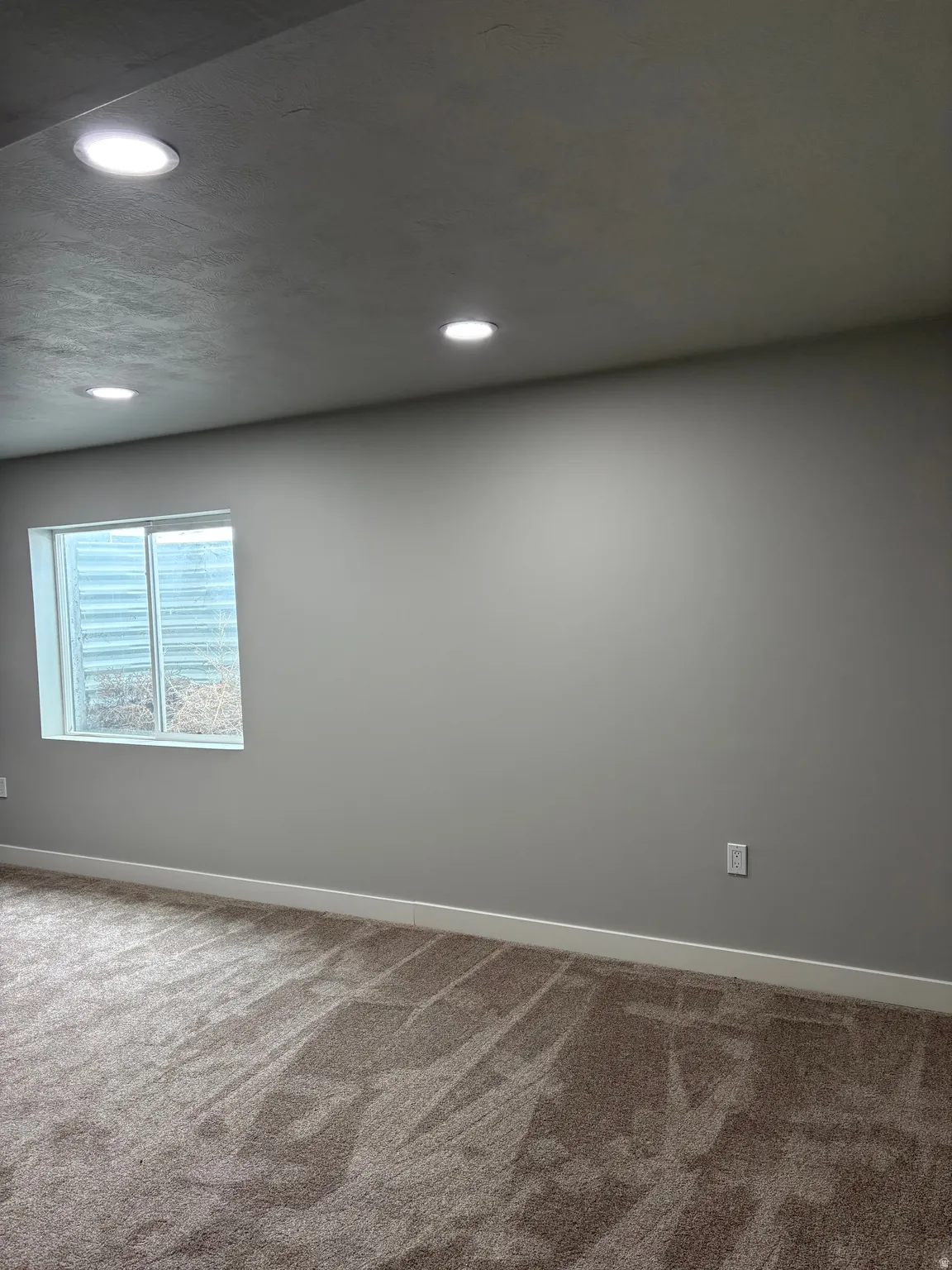 Carpeted spare room with recessed lighting and a textured ceiling