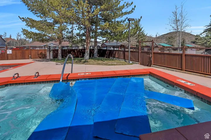 Community pool with a fenced backyard