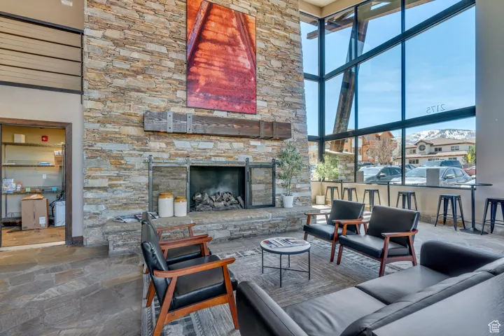 Living area featuring stone finish flooring and a stone fireplace
