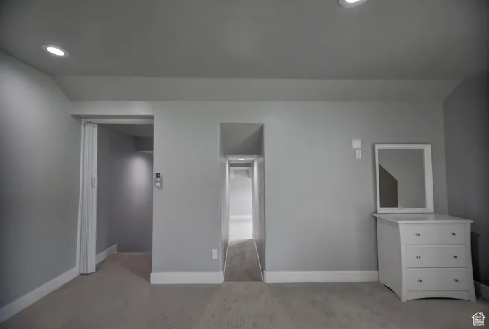 Unfurnished bedroom with light colored carpet, recessed lighting, and baseboards