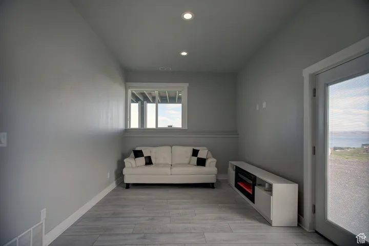 Sitting room with visible vents, recessed lighting, light wood-style floors, and baseboards