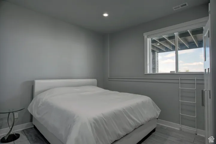 Bedroom featuring baseboards, visible vents, and recessed lighting