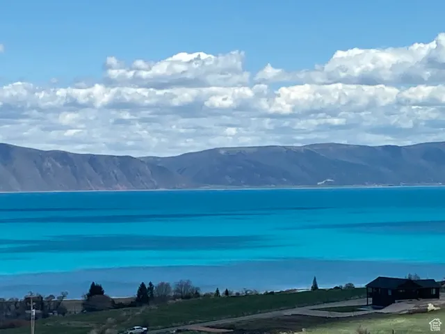 Property view of mountains with a water view