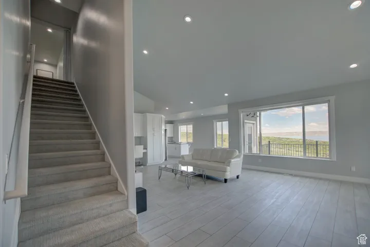Stairs with recessed lighting, wood finished floors, and baseboards