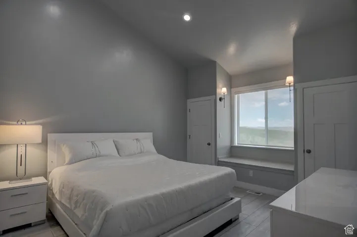 Bedroom with vaulted ceiling