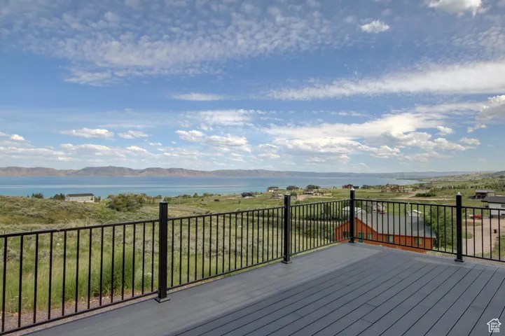 Deck with a water and mountain view
