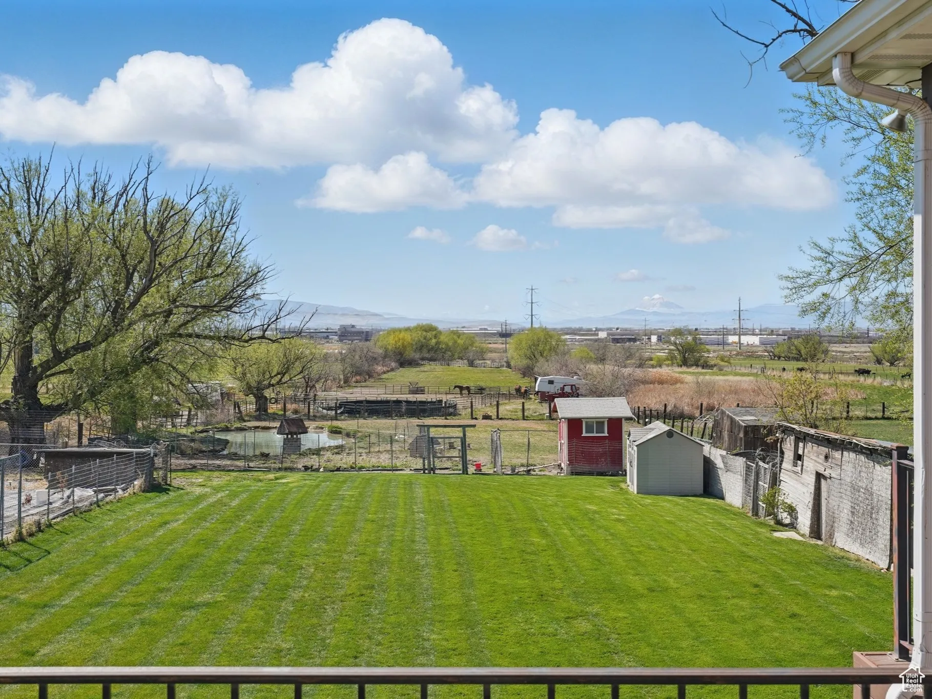 View of yard with an outdoor structure, a storage unit, and a fenced backyard
