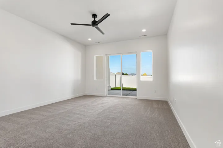 Unfurnished room featuring carpet flooring, ceiling fan, and recessed lighting